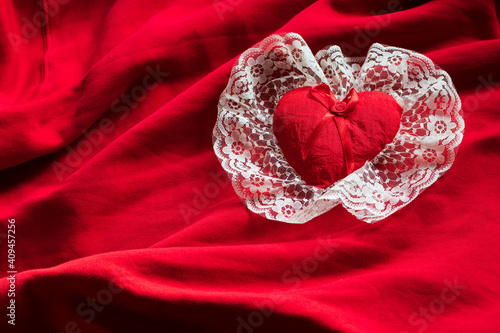 red heart white tulle on a satin red background