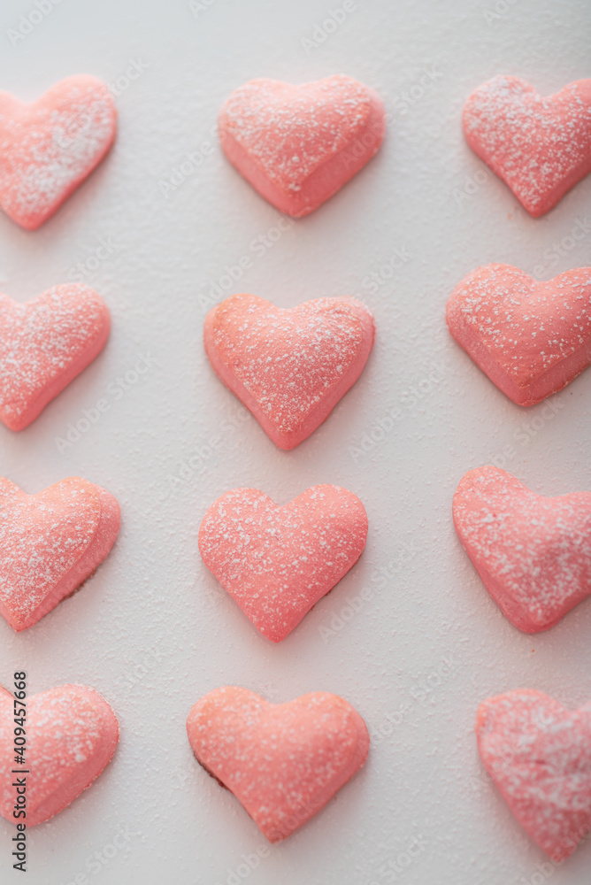 homemade pink cookies for valentine's day on a white background as a symbol of the holiday of all lovers.