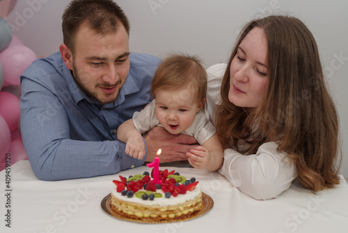 Cheerful family with birthday baby girl