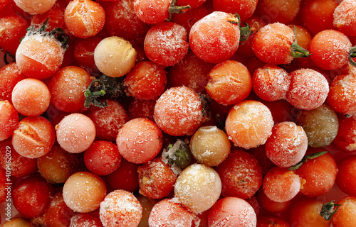 Frozen cherry tomatoes background. Frozen vegetables.
