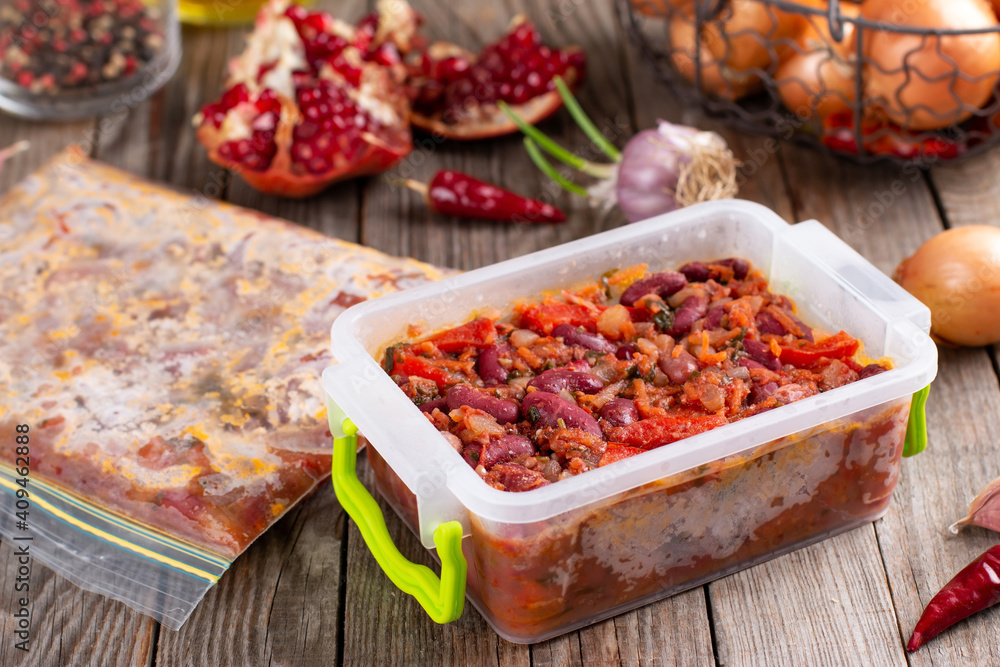 Frozen stewed red beans in tomato sauce on the table Frozen stewed red beans in tomato sauce on the table