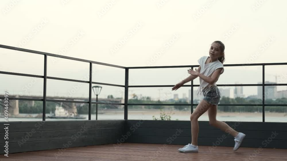Smiling girl jumping and doing twine in the air, slow motion Smiling girl jumping and doing twine in the air, slow motion