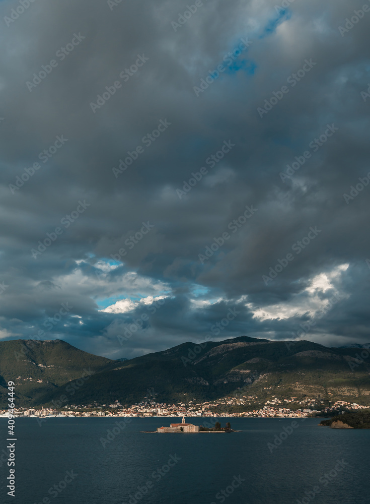 Beautiful landscape with a medieval church on an island in the sea in Montenegro. Island Gospa od Milosti in Montenegro