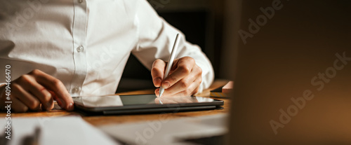 Male hands drawing on digital tablet with electronic pen. Freelancer designer working remotely. Close-up photo photo