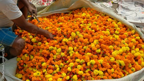 Detail of a flower seller at the Mullik Ghat flower market in Kolkata, West Bengala, India.