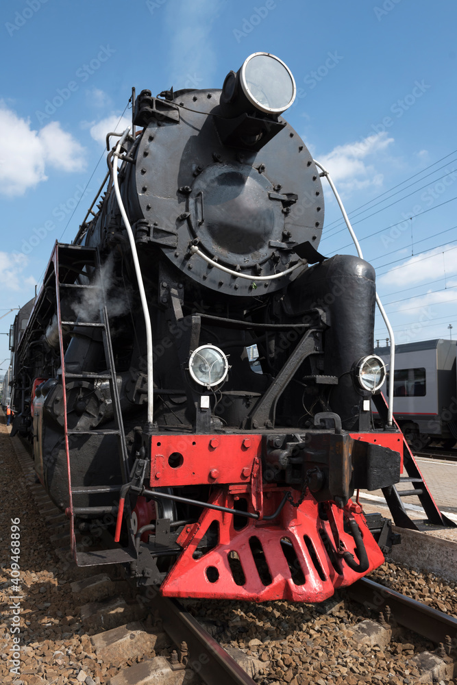 Naklejka premium The locomotive of the last century standing under steam