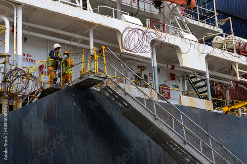 two sailors working in vessel.