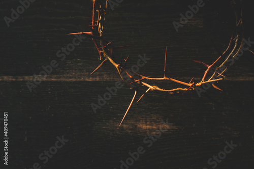 Fotografiet Crown of thorns on wooden table, closeup with space for text