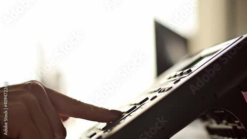 Close-up of the hand of a female office worker dialing a number on a landline phone. Faceless woman secretary calls on the phone