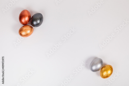 Multi-colored eggs on a uniform white background with place for text.