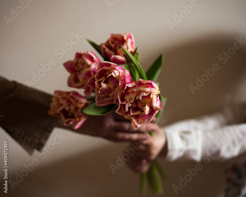  child gives mom flowers tulips .march,8, mother day background