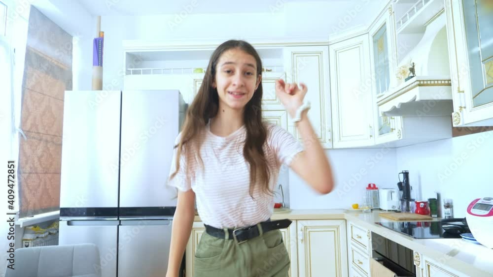 beautiful girl dancer cheerfully dancing at home in the kitchen. beautiful girl dancer cheerfully dancing at home in the kitchen.