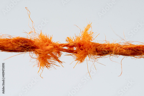 Фотография Tear test of a red thread closeup