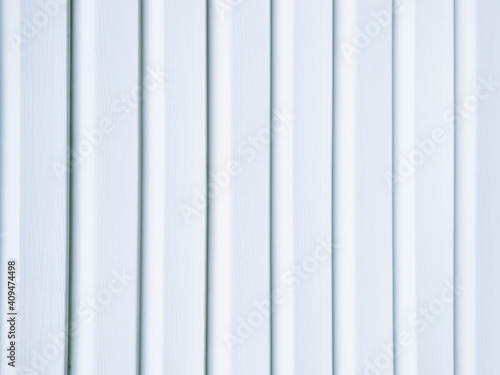 White vinyl wood siding panel background with imitation wood texture.