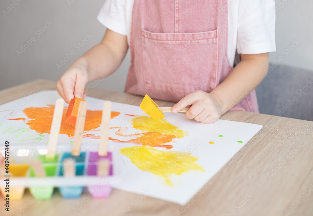 Child painting with colour ice cubes. Creative activities for toddlers. DIY, homemade paints. Child painting with colour ice cubes. Creative activities for toddlers. DIY, homemade paints.