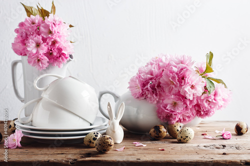 White cups and teapot, herry blossom, quail eggs, Spring still life. photo