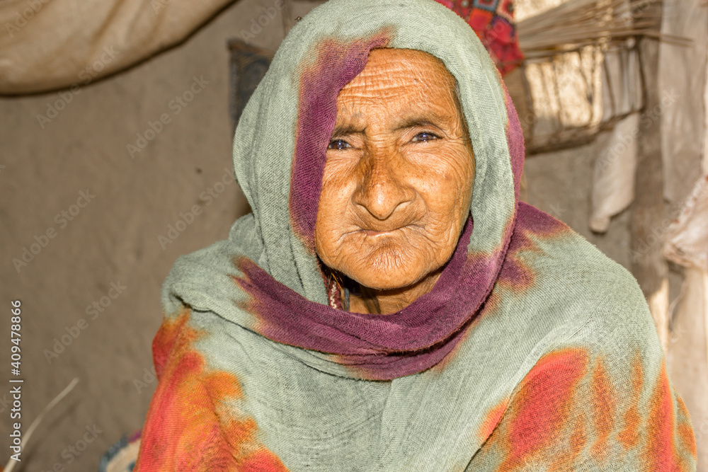 a very old Asian woman with a sad expression and wrinkles on her face a very old Asian woman with a sad expression and wrinkles on her face