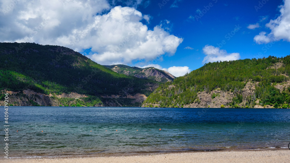 Landscape of lake Lacar, San martin de los Andes, Neuquen, Argentina. Taken on a warm summer afternoon under a ble sky with a few white clouds           