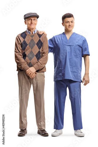 Young male doctor standing next to an elderly patient