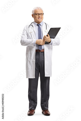 Full length portrait of a mature doctor smiling and holding a clipboard