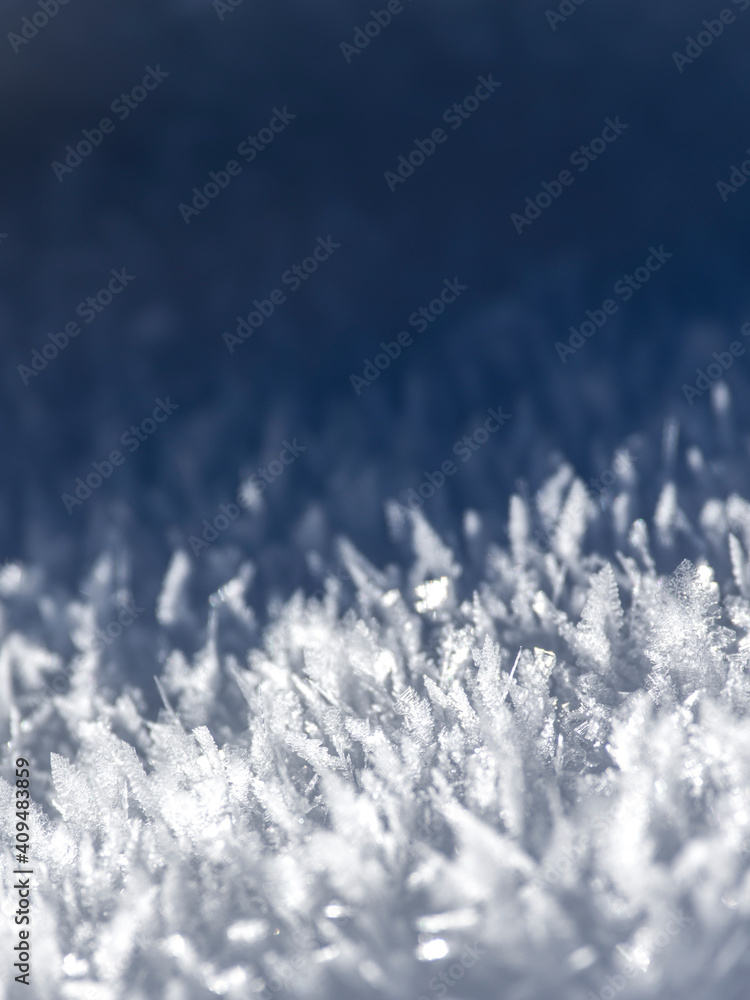 Abstract white and blue background of frozen snowflakes Abstract white and blue background of frozen snowflakes