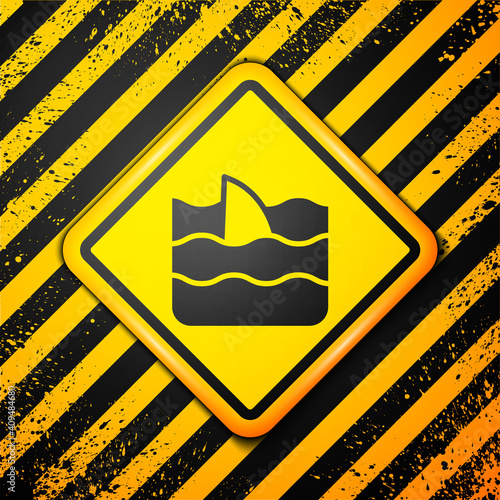 Black Shark fin in ocean wave icon isolated on yellow background. Warning sign. Vector.