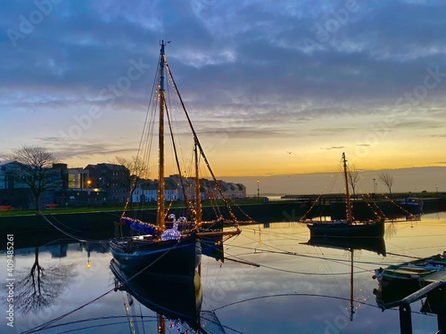 Galway hooker boats at claddagh with christmas lights