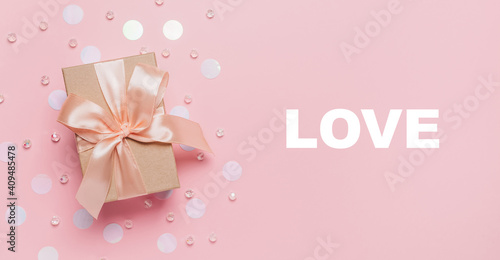 Gifts on pink background, love and valentine concept with text love © Daria Lukoiko
