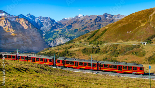 Red train is climbing to Jungfraujoch. Switzerland. 