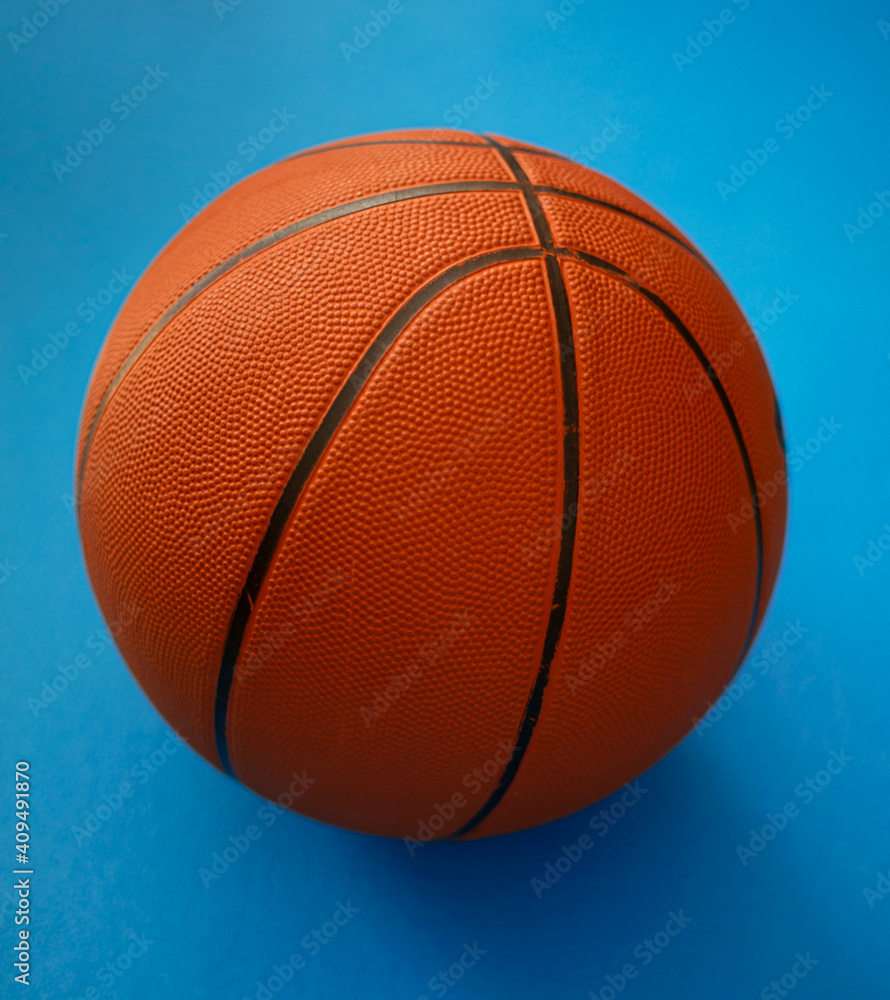 Closeup on basketball on a blue background Closeup on basketball on a blue background