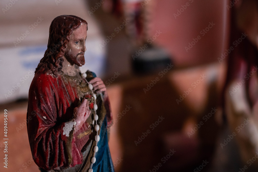 close-up of statuettes of catholic images in church cross virgin saints jesus etc abandoned in characato cordoba argentina