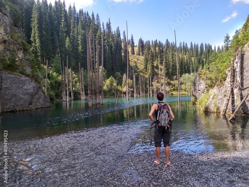 White man at the peaceful Kaindy lake in the Kazakhstan forest © Nadim