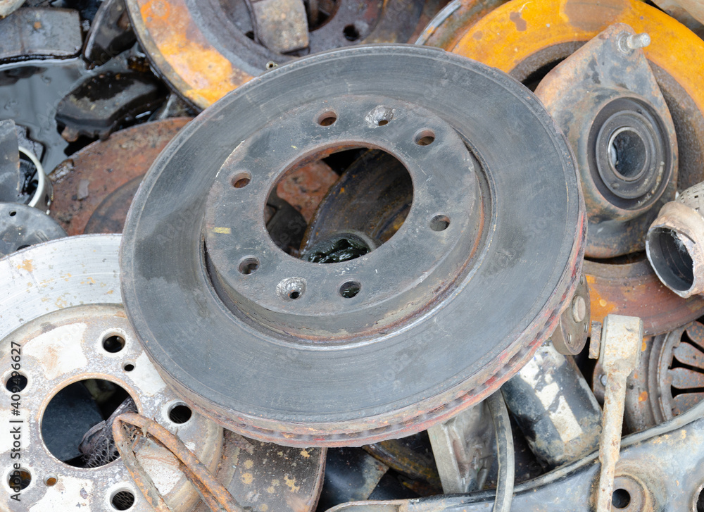 Useless, worn out old rusty brake discs and other spare parts