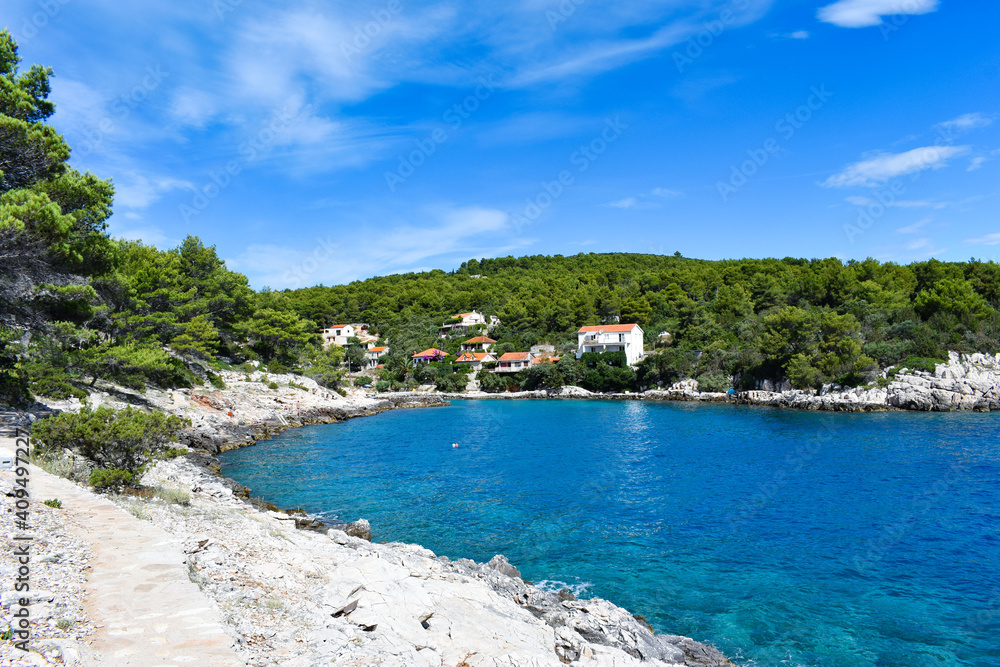 Beautiful Adriatic sea in Croatia in summer. Blue lagoon, green pines, stony coast. Footpath along the sea.Bright landscape. Mudri Dolac, Basina bay