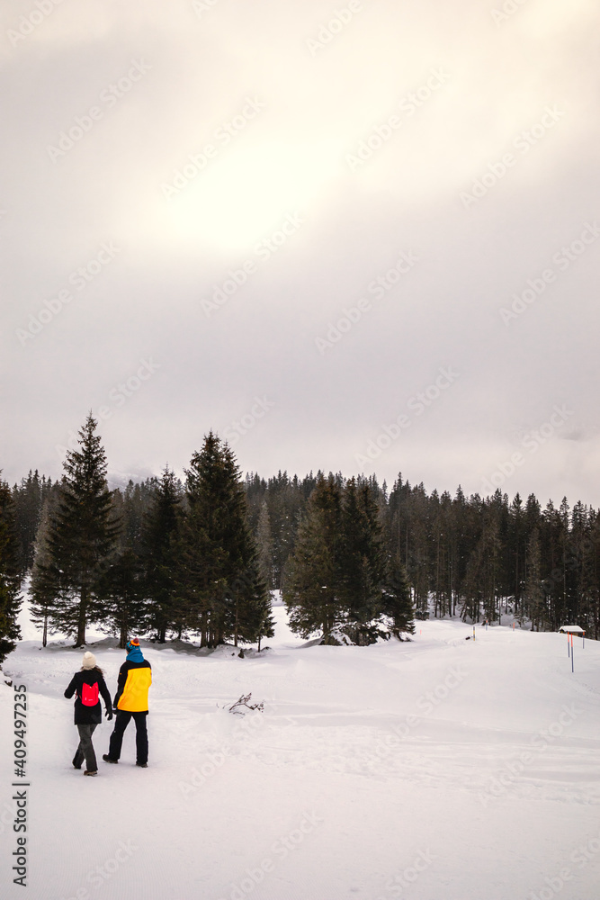 Couple walking on snowy mountain