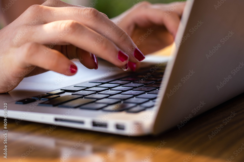 young caucasian woman works in the field on vacation connected to her computer online with sunlight young caucasian woman works in the field on vacation connected to her computer online with sunlight