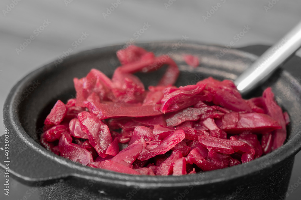 Red Cabbage in a cast iron dish pot. With selective colour Red Cabbage in a cast iron dish pot. With selective colour