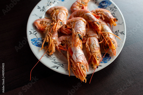Fresh and delicious seafood, cooked shrimps. Whole cooked tiger prawn on dish.Selective focus.