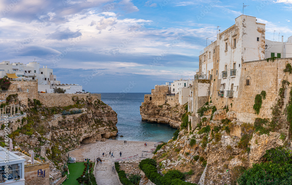 The beach of Polignano a Mare with its steep cliffs of the old town