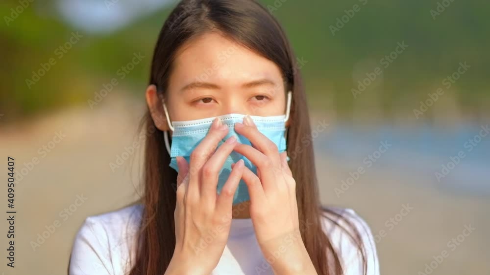 Asian woman wearing a face mask. Asian woman wearing a face mask.