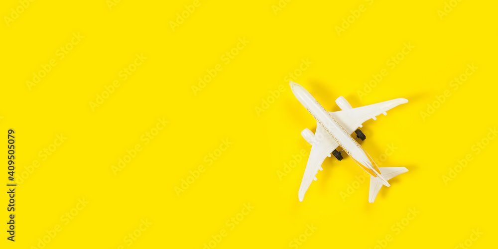 Plane model and face mask on a yellow background. Flight impact of coronavirus (COVID-19) concept. Plane model and face mask on a yellow background. Flight impact of coronavirus (COVID-19) concept.
