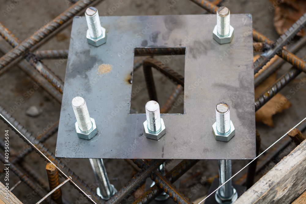 Fotka „Light pole base and anchor bolts in concrete base. Concrete base construction with light