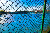 Empty tennis court. Fences of tennis court. Blue tennis court without people. 