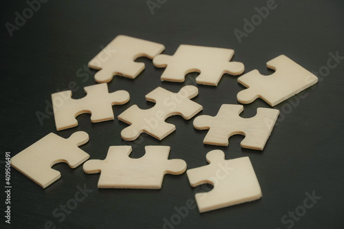 Close up piece of white jigsaw puzzle , concept of business challenge completion with teamwork