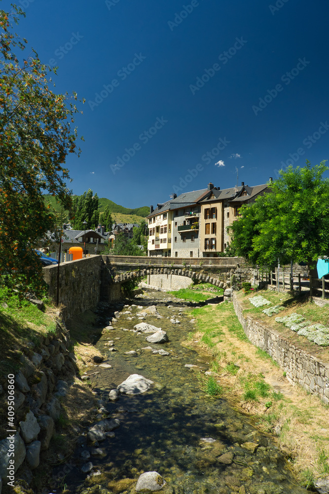 Fototapeta premium Sallent de Gallego town next to the Aguas Limpias river located in Hueca, Aragon, Spain