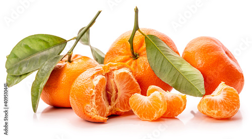 Tangerines with green leaves and peeled tangerines. Isolate on white background