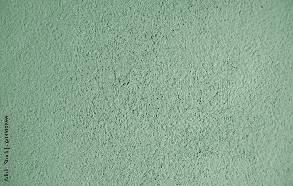 Abstract grainy texture on light green wall. It can be used as a design element and background Abstract grainy texture on light green wall. It can be used as a design element and background