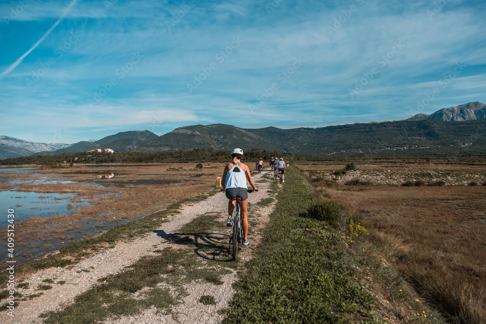 Group of people ride a bike in a nature park in Montenegro