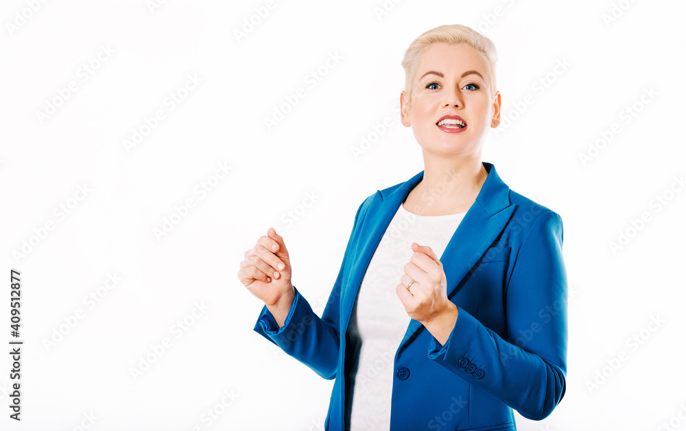 Studio portrait of expressive talking middle age woman, posing at studio on white background, wearing blue jacket Studio portrait of expressive talking middle age woman, posing at studio on white background, wearing blue jacket