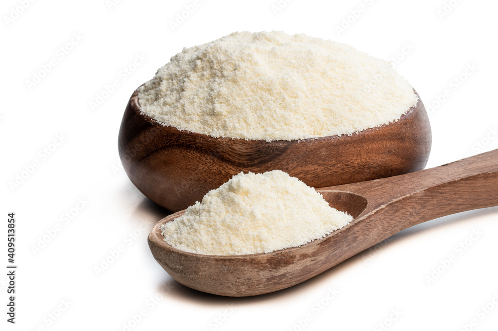 Full fat powdered milk in wooden spoon isolated on white Full fat powdered milk in wooden spoon isolated on white